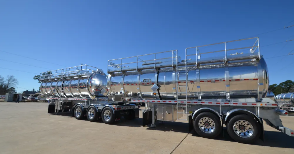Shiny metal tanker trailers for liquid transportation.
